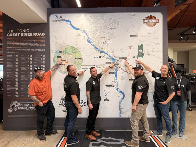 People gathered beside the Great River Harley-Davidson ride wall