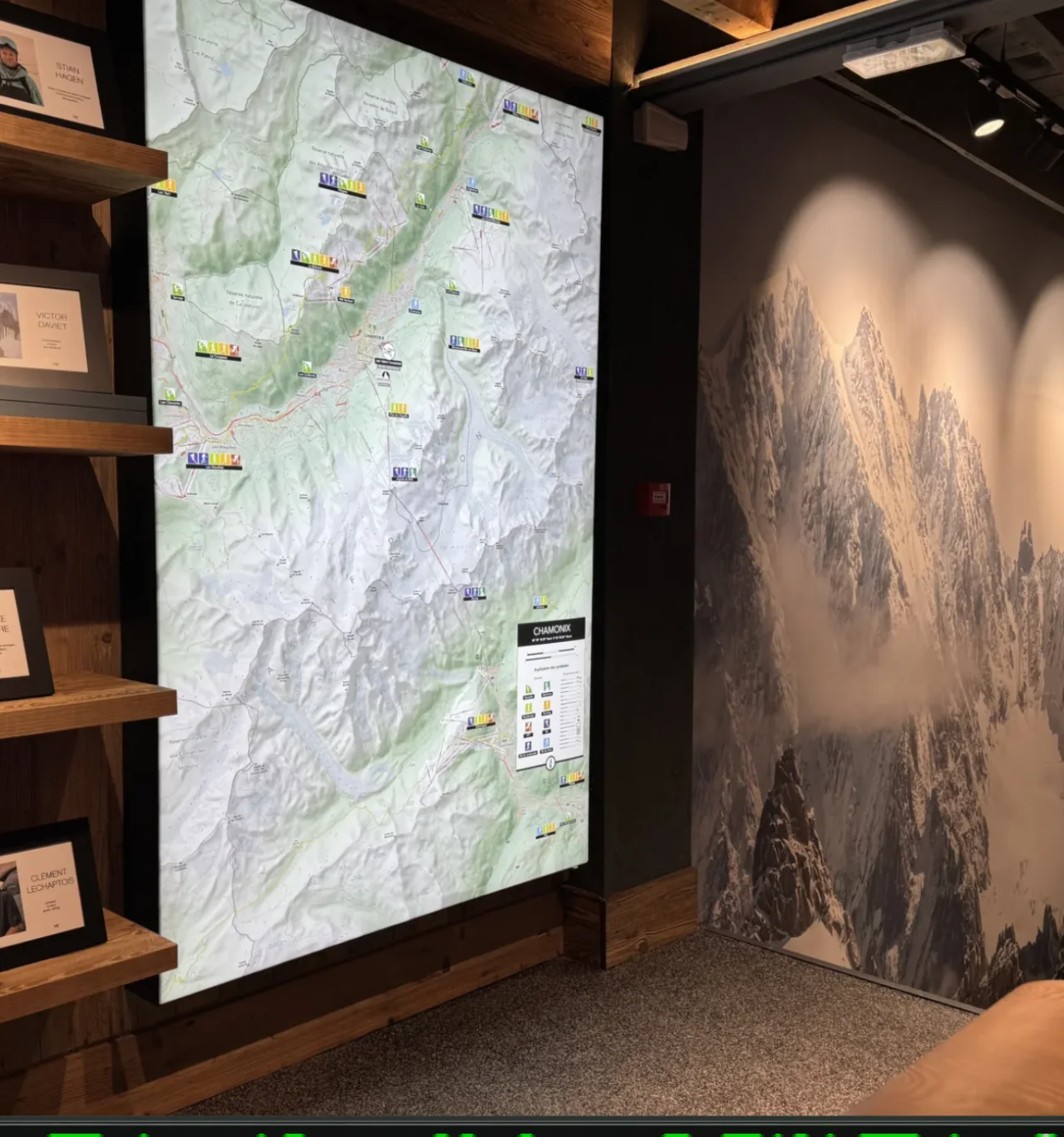 Store interior with an illuminated Chamonix trail map and mountain wall graphics