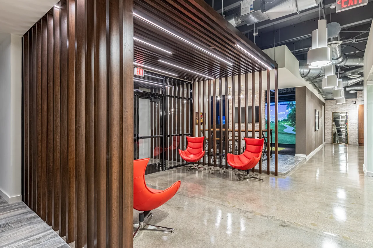 Red seating within a timber enclosure at E5 Pharma