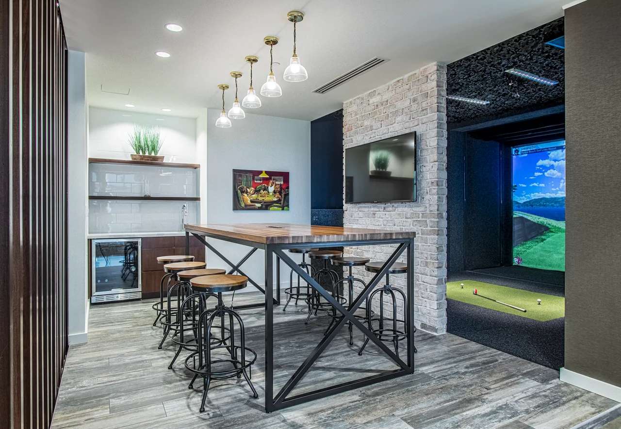 High table and kitchen lounge beside the E5 Pharma golf simulator