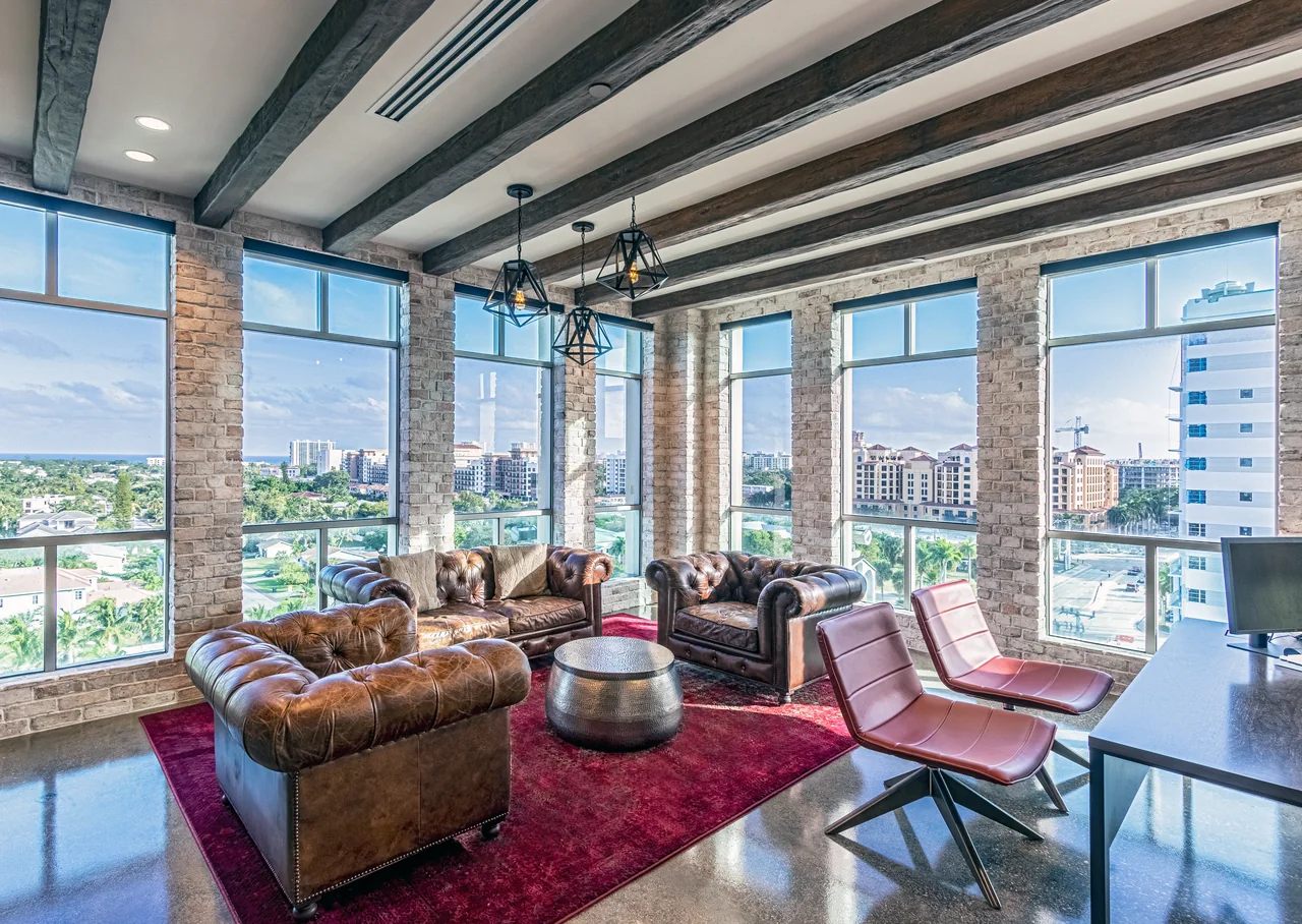 Leather seating, exposed brick and timber ceiling beams in the E5 Pharma lounge